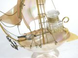 a model of a sailboat with a bottle of perfume on it