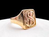 a close up of a gold signet ring with the letter s on it