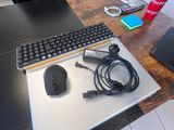 a desk with a keyboard, mouse, and a mouse pad on it