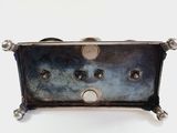 a silver toaster sitting on top of a white table