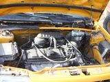 a yellow car that has a engine in it