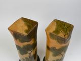 two vases that have been painted with trees on them