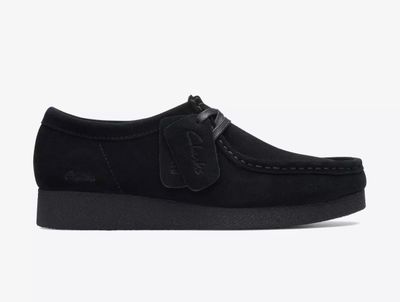 un gros plan d'une chaussure noire sur fond blanc