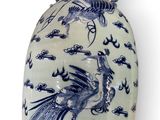 a blue and white vase with a bird on it