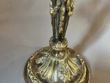 silver plated candle holder with a figurine of a man and a woman