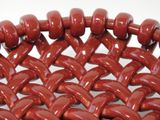 a close up of a basket made of red beads