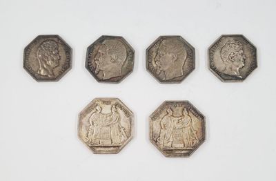 six different types of coins on a white surface