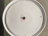 an overhead view of a white drum with a red knob on it