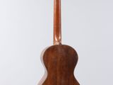 a close up of a wooden guitar hanging from a string
