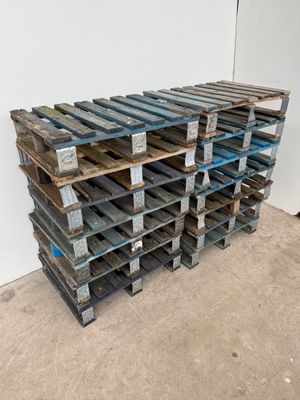 several wooden pallets stacked on top of each other in a room