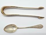two spoons and a spoon rest on a white surface