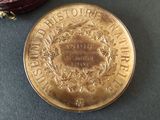 a gold coin sitting next to a purple purse