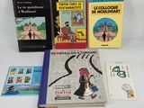 several children ' s books are lined up on a white surface