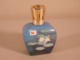 a blue vase with water lilies painted on it