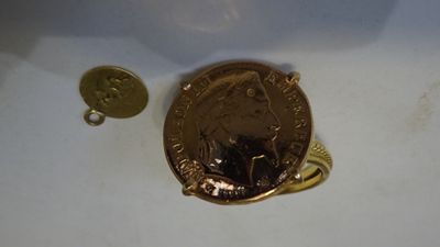 a penny and a coin sitting on a white surface