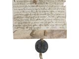 un vieux bout de papier auquel est collée une pièce de monnaie
