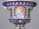 a blue and white vase with a picture of an angel on it