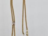 a gold chain with a tag attached to it