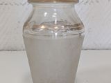 a small glass vase with a lid on a table