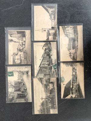 a black and white photo of a bunch of old postcards