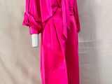the dress is pink and has a tie on the waist