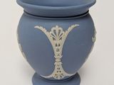 a blue vase with a white design on it