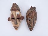 pair of african masks on a white background