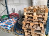a stack of pallets sitting next to a pile of other pallets