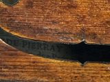 a close up of a piece of wood on a violin