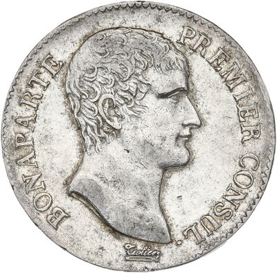 Gros plan sur une pièce d'argent portant une tête d'homme