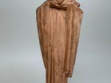 statue of a man with a hat and robe on a pedestal