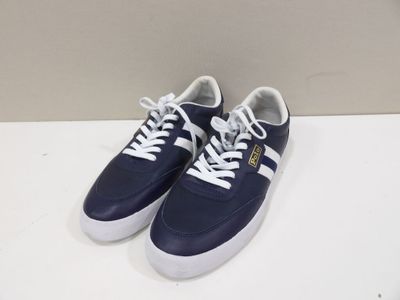 a pair of blue and white sneakers on a white surface