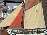 a model of a sailboat on display in a museum