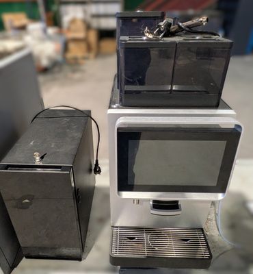 two microwaves sitting on top of each other on a table