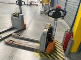 two forklifts that are parked in a warehouse