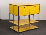 a yellow shelf with two drawers on top of it