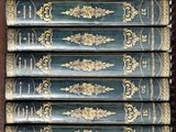 a lot of books stacked on top of each other on a shelf