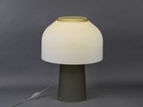 a close up of a lamp on a table with a gray background