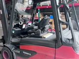 a pink forklift truck parked in a warehouse