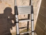 a ladder leaning against a wall next to a brick wall