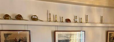 many framed pictures on the wall of this room