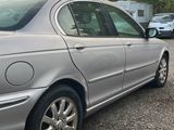 a picture of a silver car parked in a parking lot