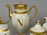 a white and gold tea set with gold trims