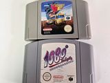 two nintendo game cartridges sitting on top of each other
