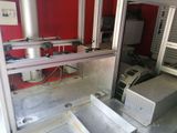a machine that is sitting in a room with a red wall