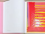 an open book with a picture of a sun in the background