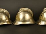 three helmets sitting on top of each other on a table