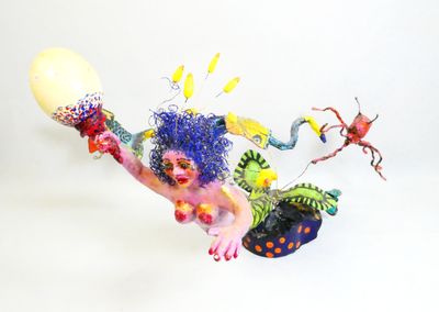 a sculpture of a clown with a balloon and other items