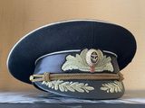a black hat with a gold emblem on it