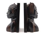 pair of bookends of a woman ' s head and a man ' s head